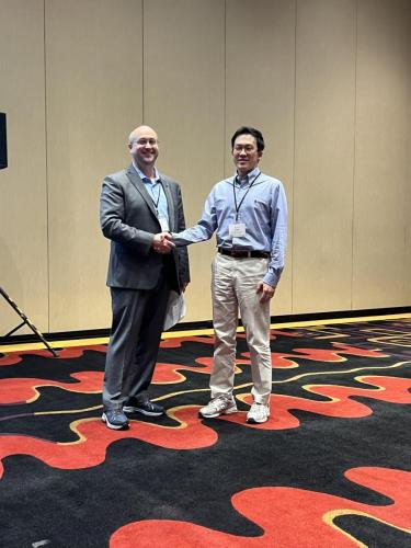 SWFA VP Andrew Lynch presents Seungho Choi with best paper award in ESG. 